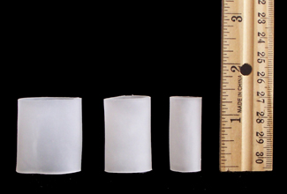 pedifix gel toe sleeve all three sizes next to ruler showing height of about one and a half inch